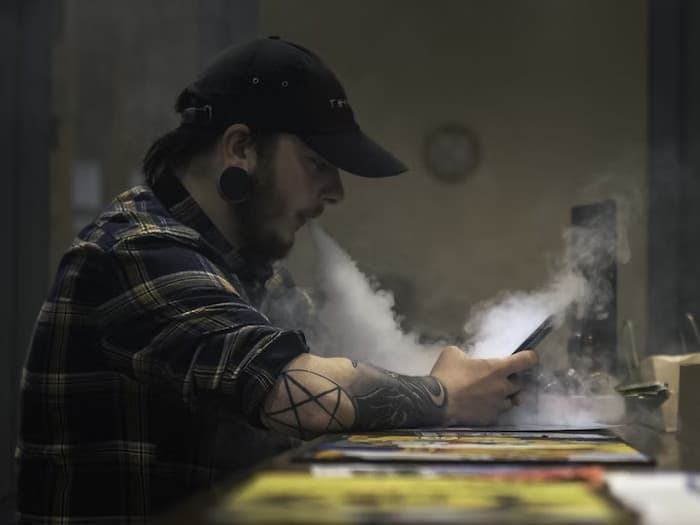 man vaping inside a room